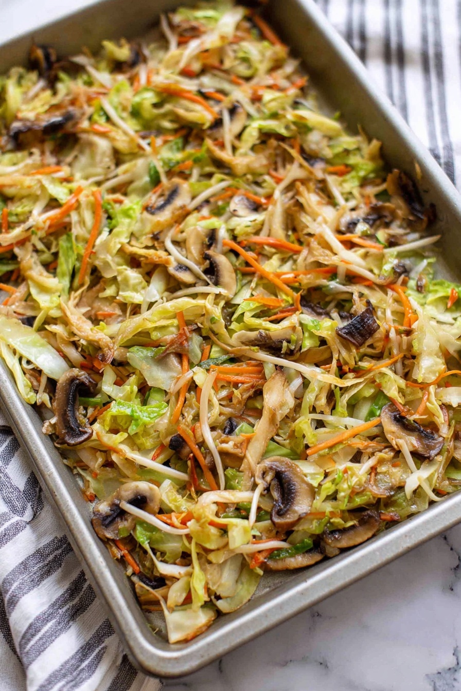 A close-up image shows a deep golden brown fried roll being dipped into a small white bowl filled with a shiny, light amber sauce with red chili flakes floating on top. The roll has a crispy, textured outer layer with a visible inner layer of soft white dough. Inside, thin slices of light brown shiitake mushrooms, orange shredded carrots, pale yellow cabbage, and green herbs are layered tightly. The bowl sits on a larger white plate with several more fried rolls blurred in the background. A woman's hand holds the roll gently, and a few fresh green herb leaves lie on the white marbled surface beneath the plate. Photo taken with an iphone --ar 2:3 --v 7